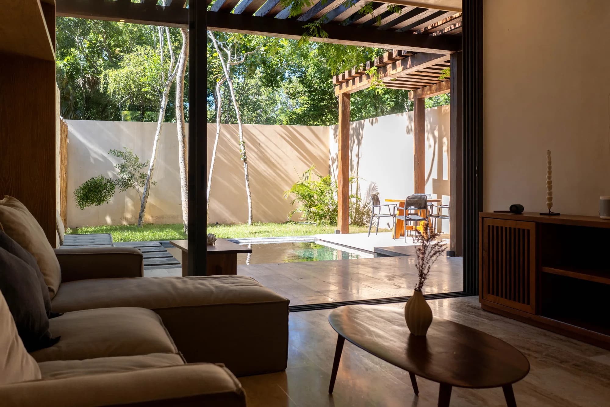 Sala abierta hacia la terraza y alberca en Junglar